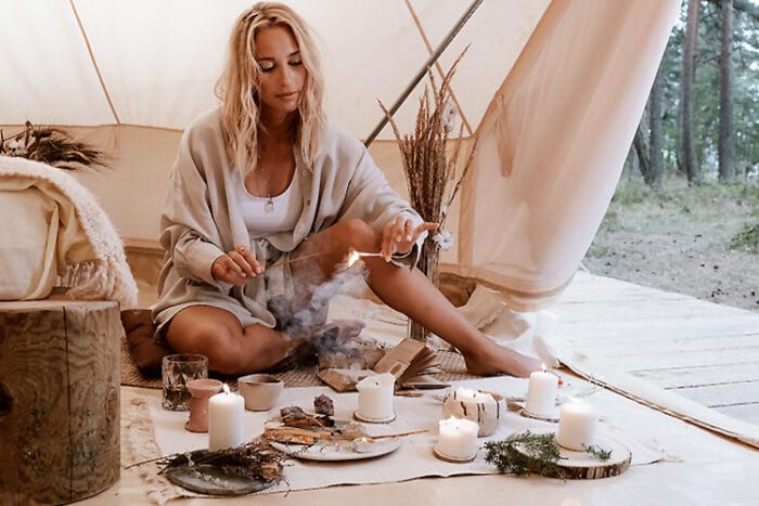 Lady relaxing and making a wish with Incense and Candles